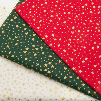 Small gold stars are printed on christmas cotton fabric