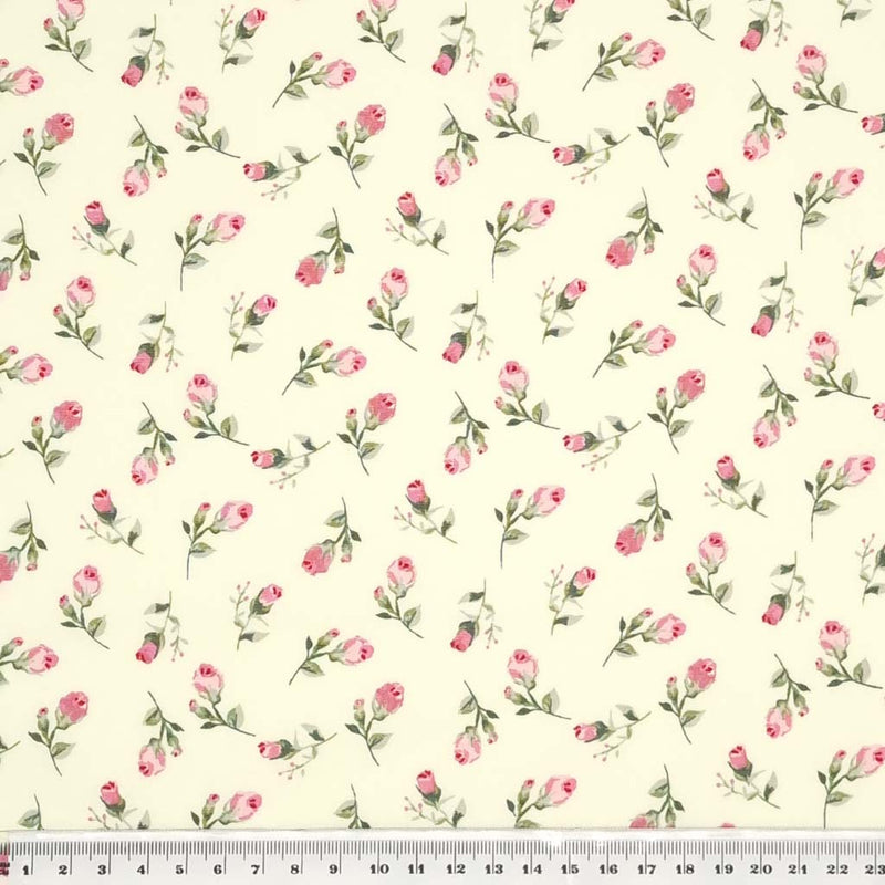 A pink ditsy floral print on cotton poplin fabric