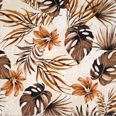 Dark brown and golden leaves are printed on a cream cotton sateen fabric