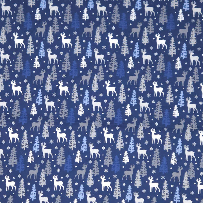Pattern of deer and trees on a blue christmas cotton fabric