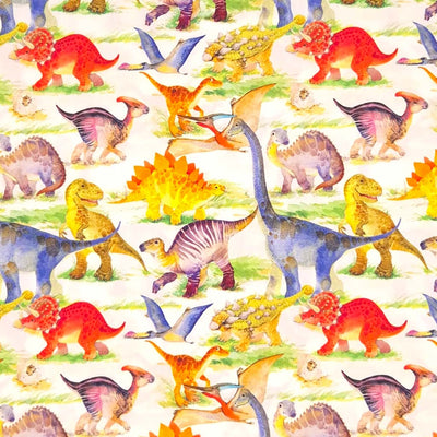 Colourful dinosaurs are printed on an ivory cotton poplin fabric