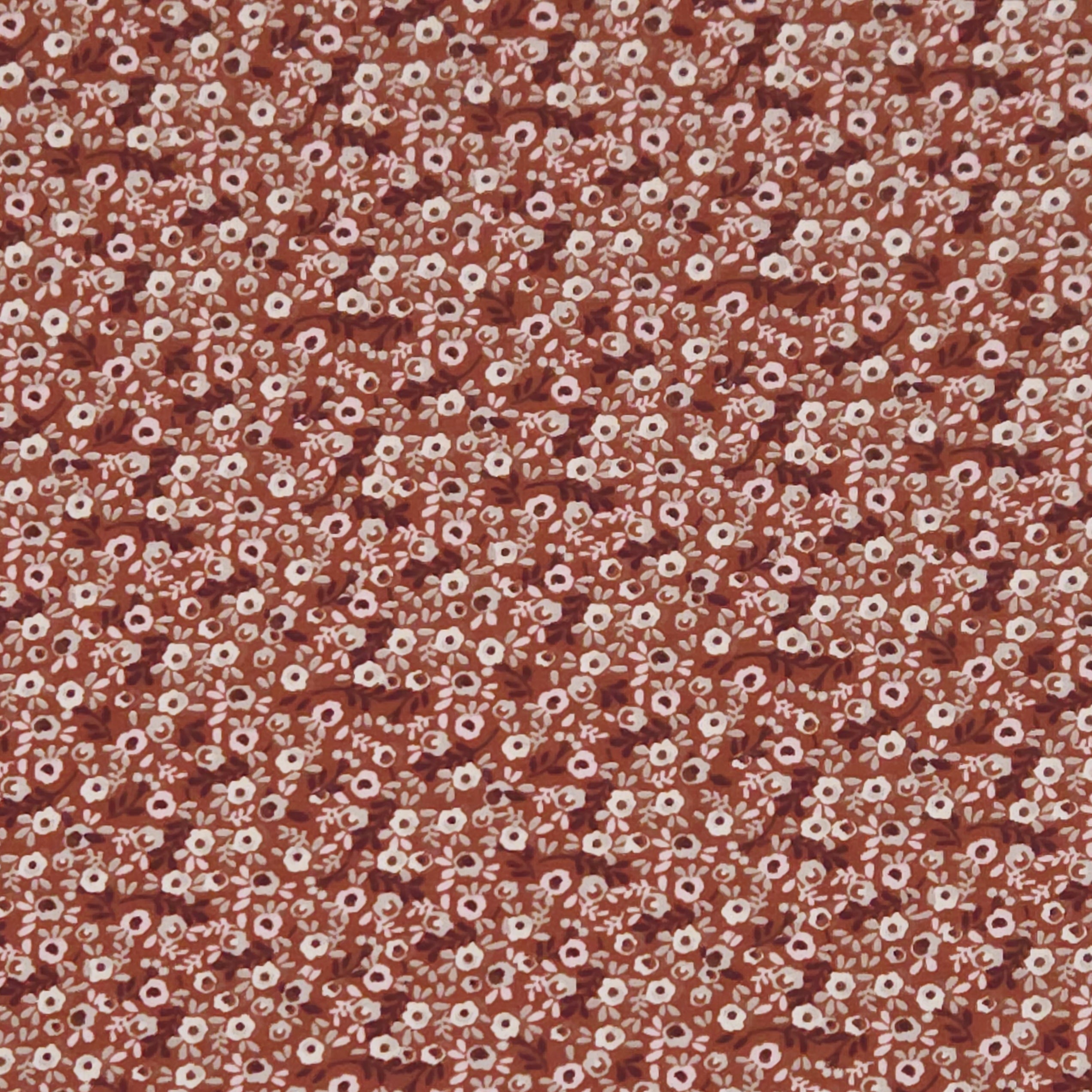 Ditsy flowers printed on a brown cotton jersey fabric