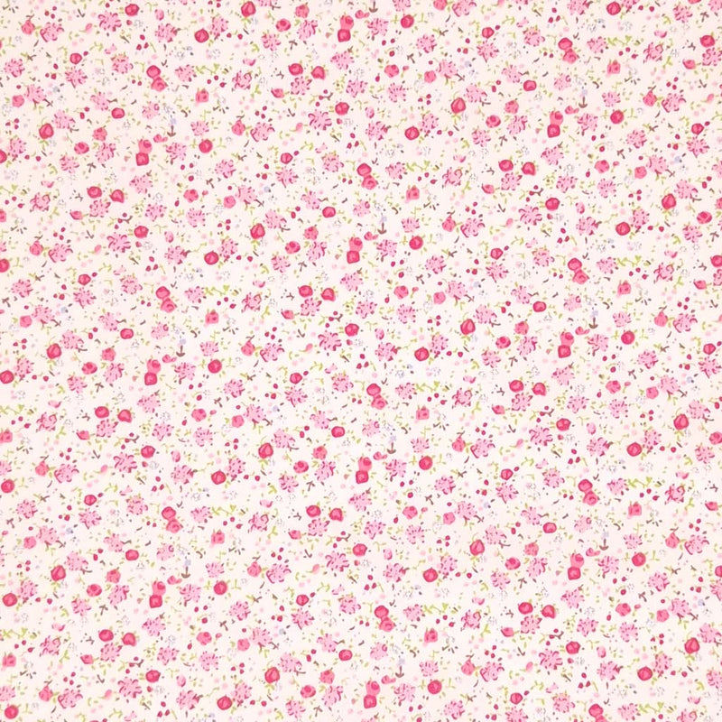 Ditsy floral pattern with pink flowers on a cream background