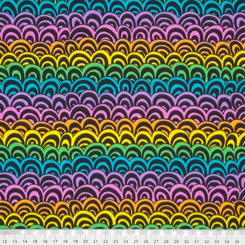 A colourful doodle rainbow print on a black polycotton fabric with a cm ruler