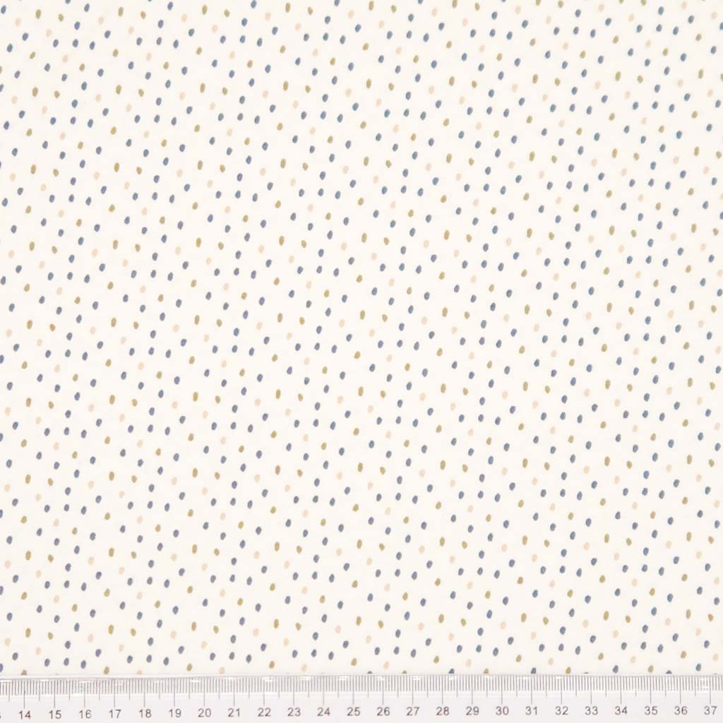 Ditsy dots printed on a cream cotton jersey fabric with a cm ruler