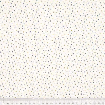 Ditsy dots printed on a cream cotton jersey fabric with a cm ruler
