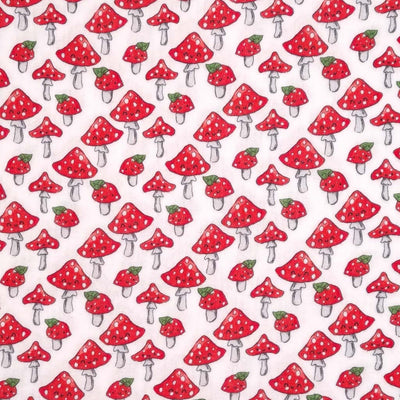 Jolly mushrooms with red caps printed on a white double gauze fabric