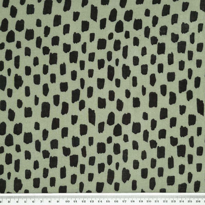 Black blocks are printed on an olive green double gauze fabric with a cm ruler