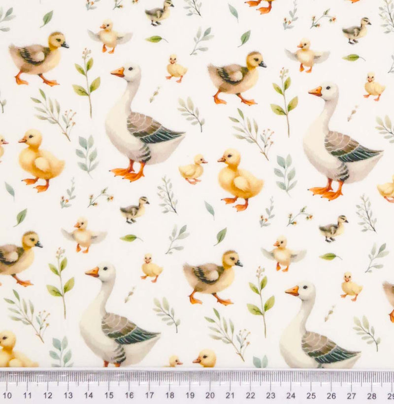 Ducks and ducklings printed on an ivory cotton poplin fabric with a cm ruler