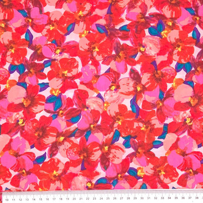 Rich red and pink petals printed on a pima cotton lawn with a cm ruler