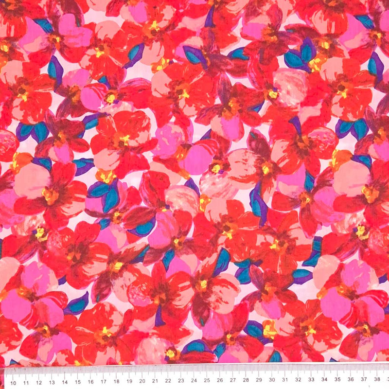 Rich red and pink petals printed on a pima cotton lawn with a cm ruler