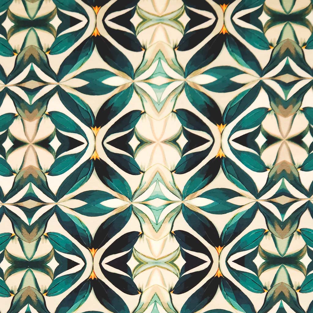 An emerald green mandala pattern printed on a cotton jersey fabric