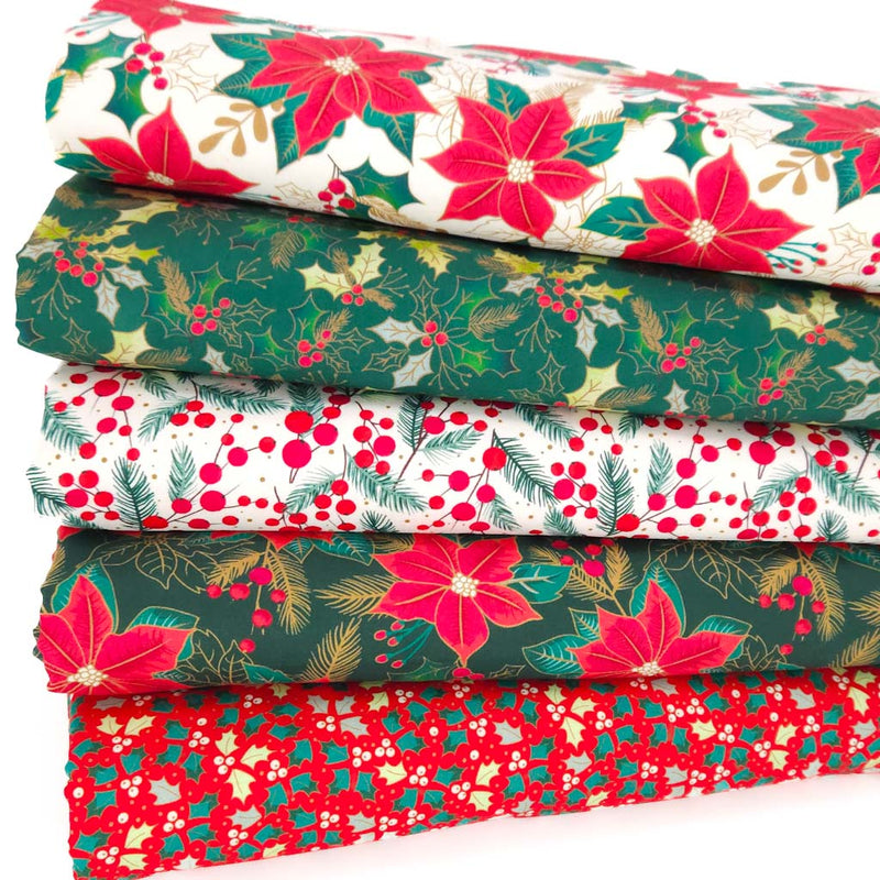 Fat quarter bundle of Christmas-themed fabrics with poinsettias and holly leaves.