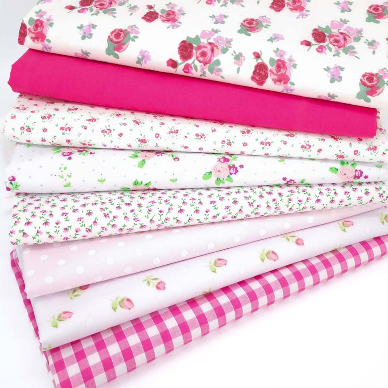 A bundle of polycotton fat quarters in various shades of pinks with spots and floral prints
