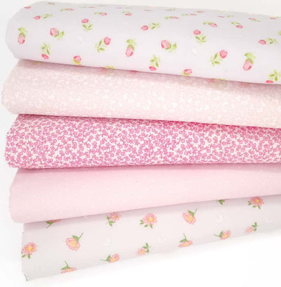 Five pink polycotton floral fabric prints are arranged in a fat quarter bundle