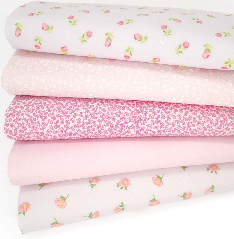Five pink polycotton floral fabric prints are arranged in a fat quarter bundle