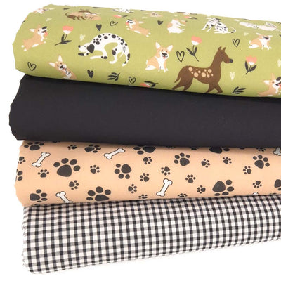 A fat quarter bundle of four dog themed fabric prints