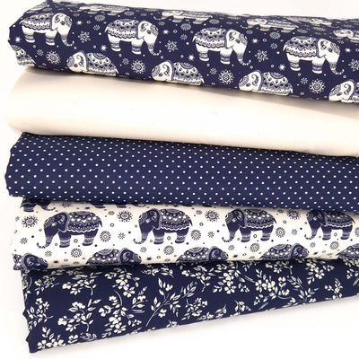 A fat quarter bundle of five cotton poplin fabrics with elephants, spots and fern floral in navy and ivory