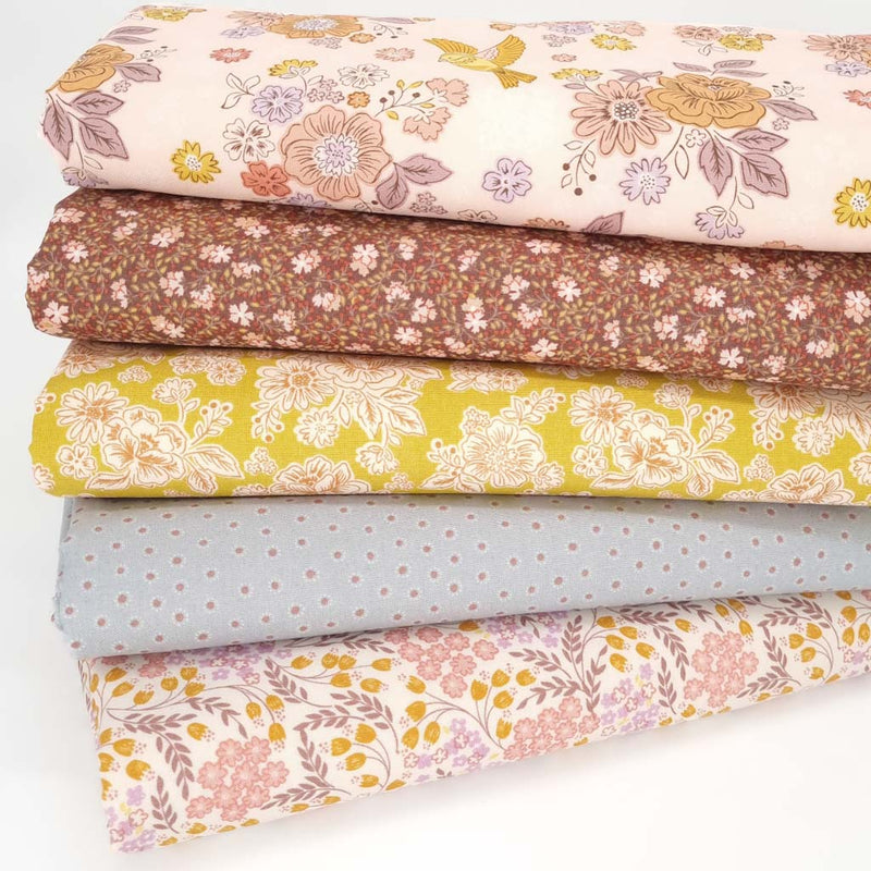 A fat quarter bundle of five cotton quilting fabrics with floral prints by Lewis & Irene