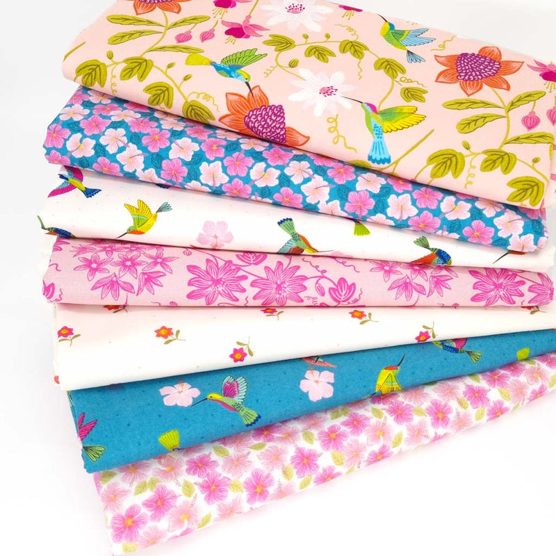 A colourful bundle of 7 fat quarters printed with hibiscus florals and hummingbirds