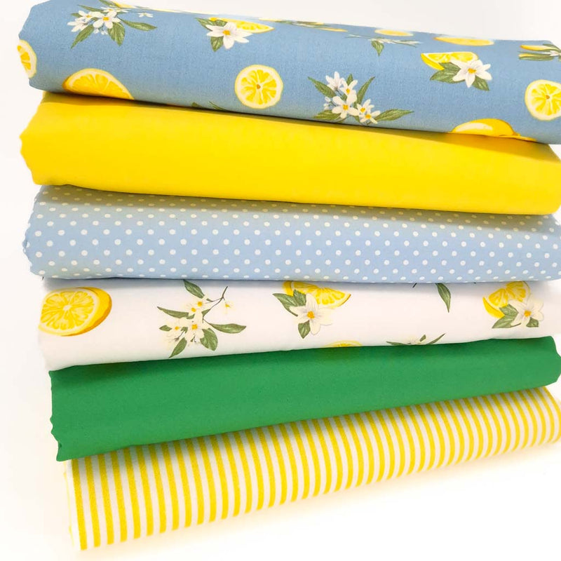 A fat quarter bundle of 6 lemon themed cotton poplin fabric prints