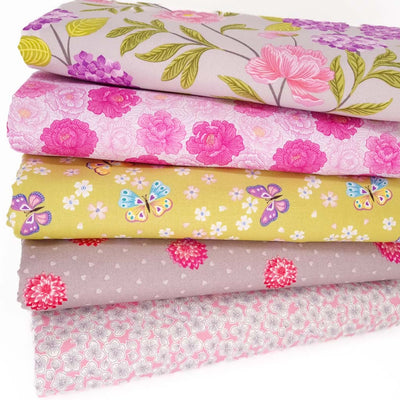 A fat quarter bundle of 5 floral quilting fabrics in neutral and pink tones