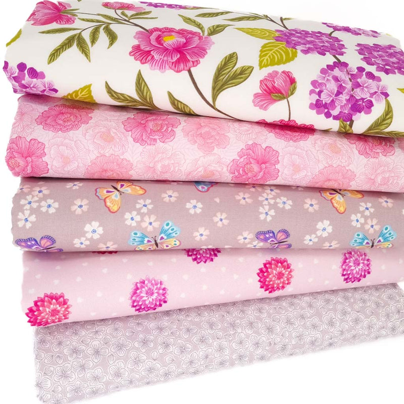 A fat quarter bundle of 5 floral and butterfly fabric prints in pinks and neutrals