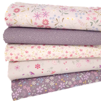 A fat quarter bundle with pressed flowers printed on cotton quilting fabric by Lewis & Irene