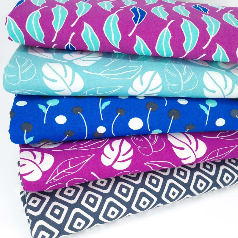 A purple and blue cotton floral fat quarter bundle with leaves and geometric patterns