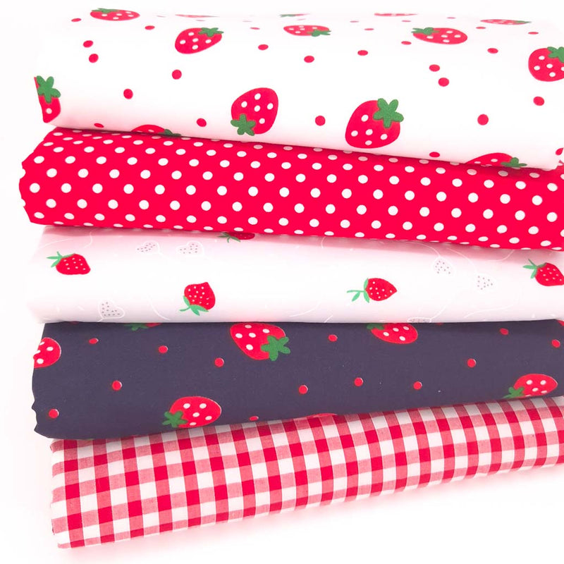 A fat quarter bundle of strawberries, spots and gingham on polycotton fabric