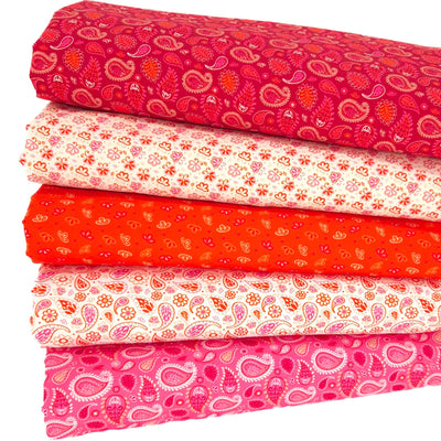 A fat quarter bundle of five cotton paisley prints in reds and oranges