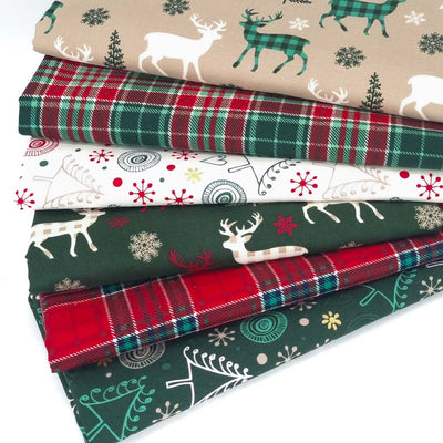 A bundle of 6 christmas fat quarters with check reindeer and festive tartan prints