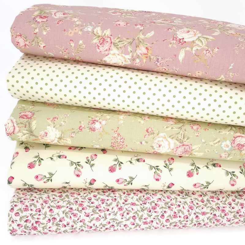 Five floral cotton fabrics in a bundle with a rose coloured design on top, a spot, a green rose and two ditsy designs
