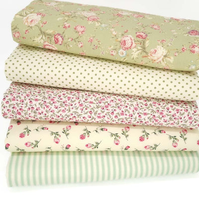 A fat quarter bundle with 5 mint coloured designs with spots, stripes and floral cotton poplin fabrics