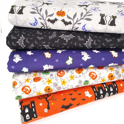 A fat quarter bundle of five spooky halloween glow in the dark cotton fabrics with bats, pumpkins and ghosts