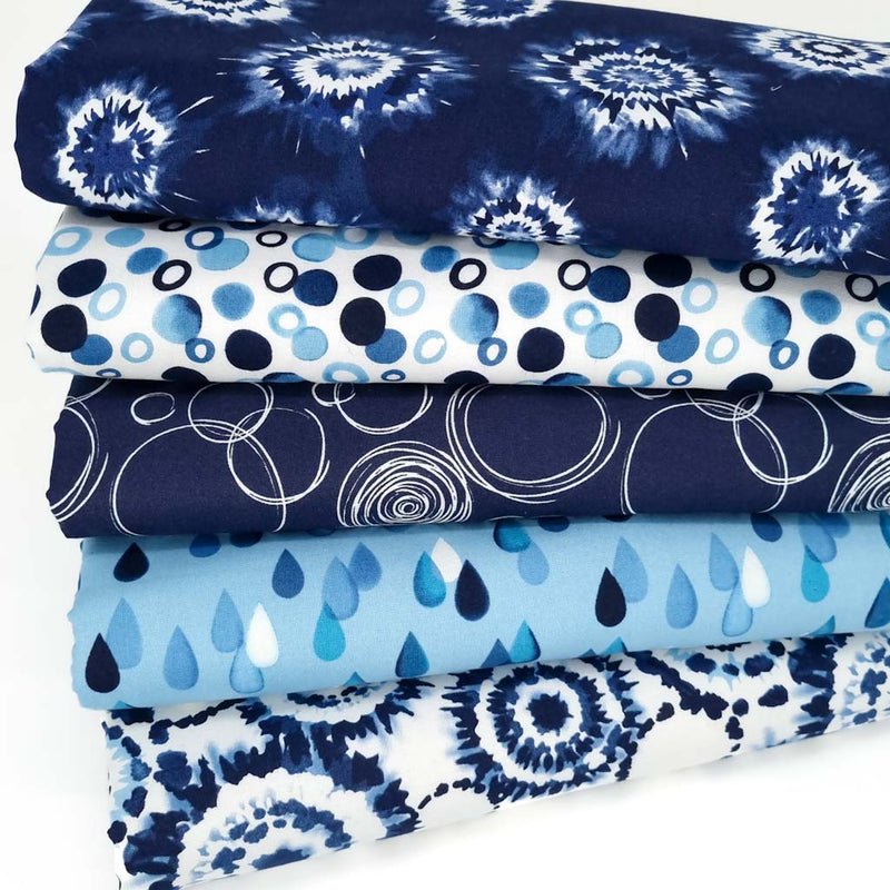 A fat quarter bundle with a funky indigo tie dye theme printed on 100% cotton fabrics