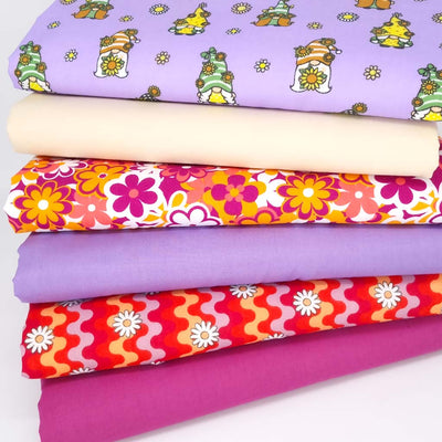A fat quarter bundle of 6 designs with gonks and retro florals in lilacs and magenta