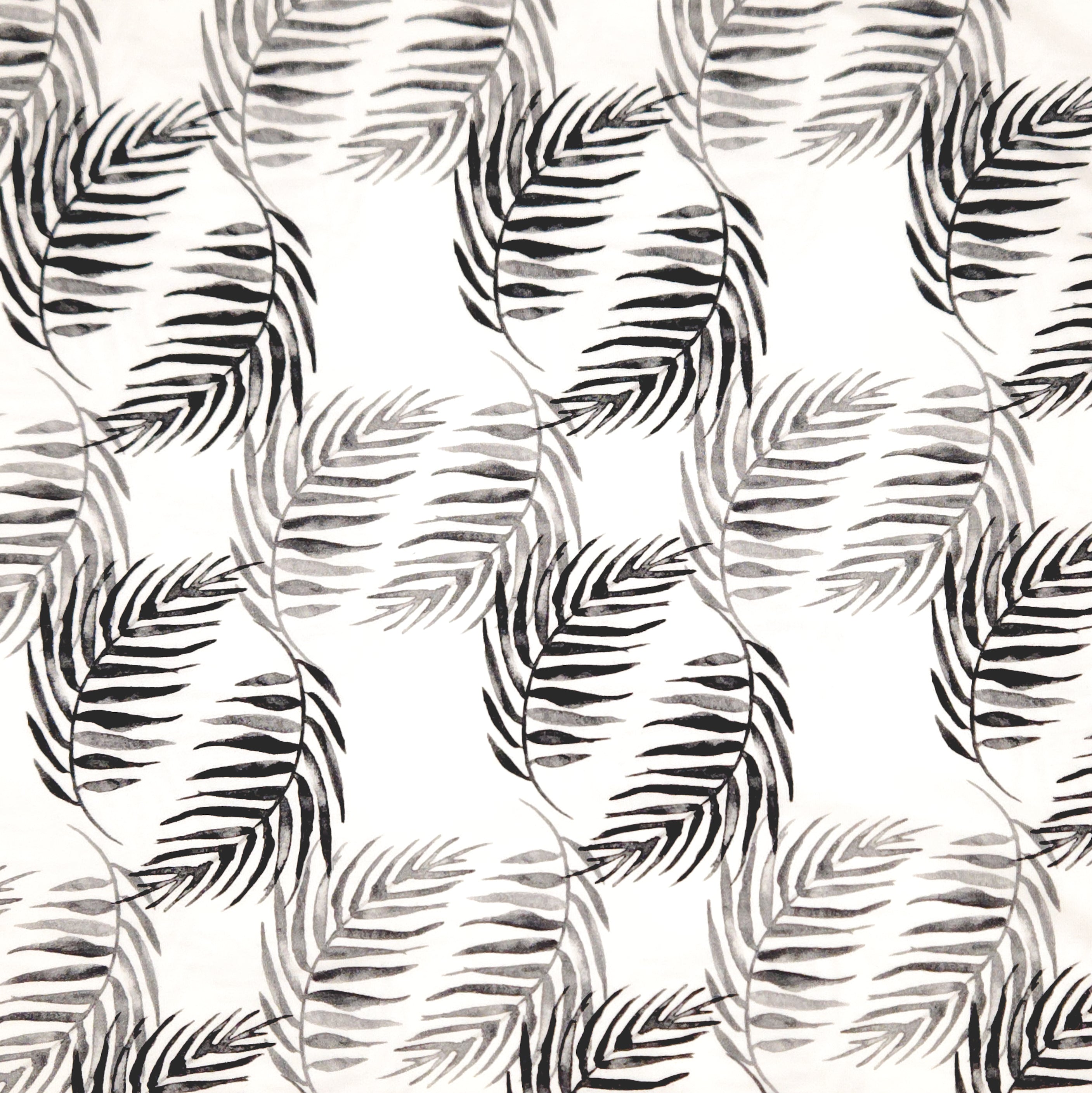 Black and grey palm leaves printed on a white cotton jersey fabric