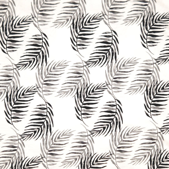 Black and grey palm leaves printed on a white cotton jersey fabric