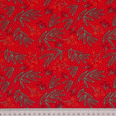 A festive holly fabric print on a red polycotton with a cm ruler