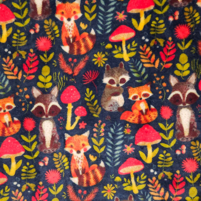 Pattern of foxes, raccoons, and mushrooms on a dark blue cuddle fleece fabric