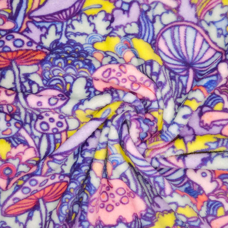 Colourful pattern of mushrooms and flowers with a psychedelic design printed on cuddle fleece fabric with folds