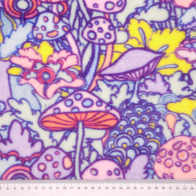 Colourful pattern of mushrooms and flowers with a psychedelic design printed on cuddle fleece fabric with a cm ruler
