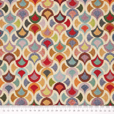 A colourful geometric design printed on a tapestry upholstery fabric with a cm ruler