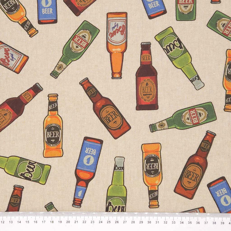 Pattern of colourful beer bottles on a beige canvas fabric with a cm ruler