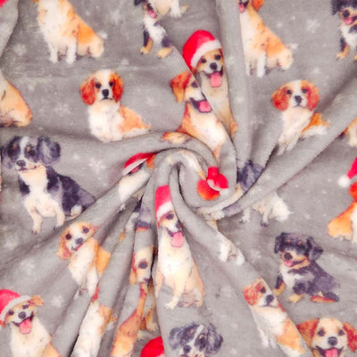 Pattern of dogs wearing Santa hats on a gray cuddle fleece with snowflakes with folds