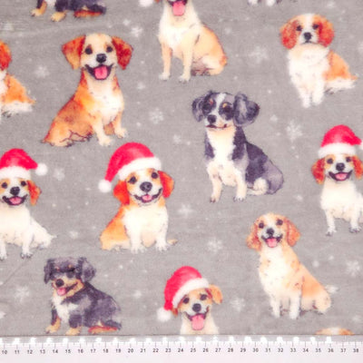 Pattern of dogs wearing Santa hats on a gray cuddle fleece with snowflakes with a cm ruler