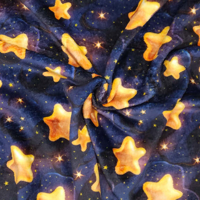 Pattern of yellow stars on a dark blue cuddle fleece fabric with folds