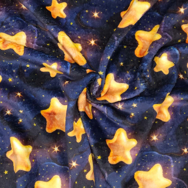 Pattern of yellow stars on a dark blue cuddle fleece fabric with folds
