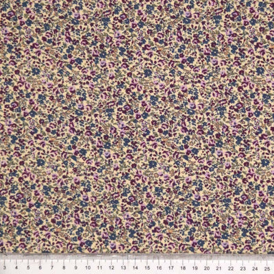 Purple ditsy floral print on needlecord fabric with a cm ruler